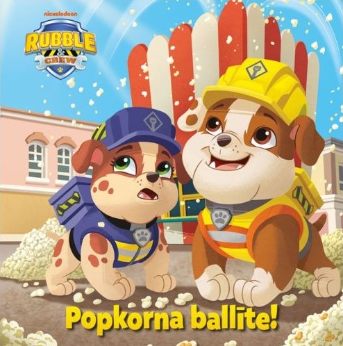 Bērnu grāmatas "Rubble & Crew. Popkorna ballīte!" vāks. Divi animēti kucēni dzeltenās un zilās celtnieku cepurēs stāv starp popkorna kaudzēm.